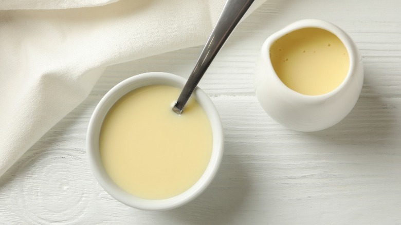 Two small containers of evaporated milk