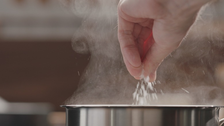 Salting water in steaming pot