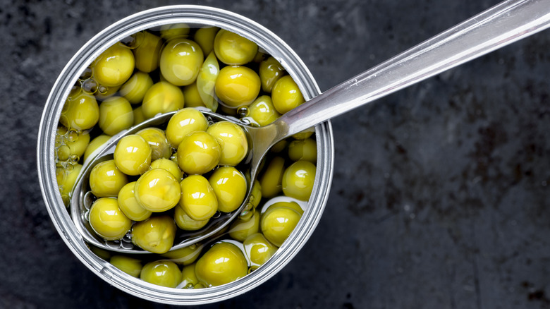 Canned peas with spoon inside