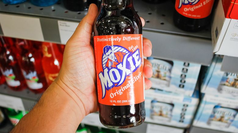 Hand holding Moxie soda