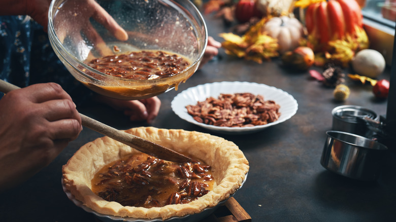 filling pecan pie crust