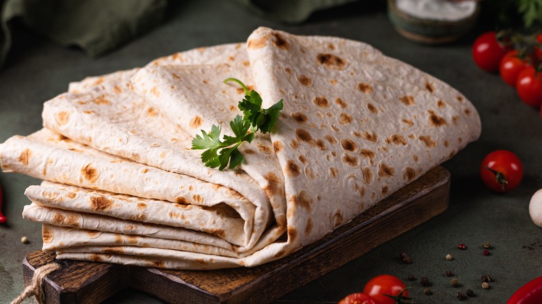 Rolled lavash on wooden board