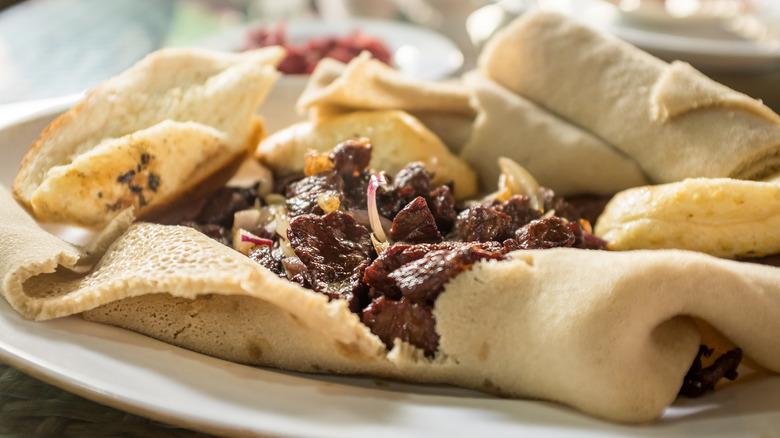 Tibs with Injera on plate