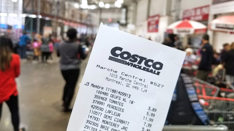 person holding costco receipt