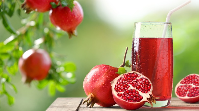 Pomegranate fruit and juice in glass