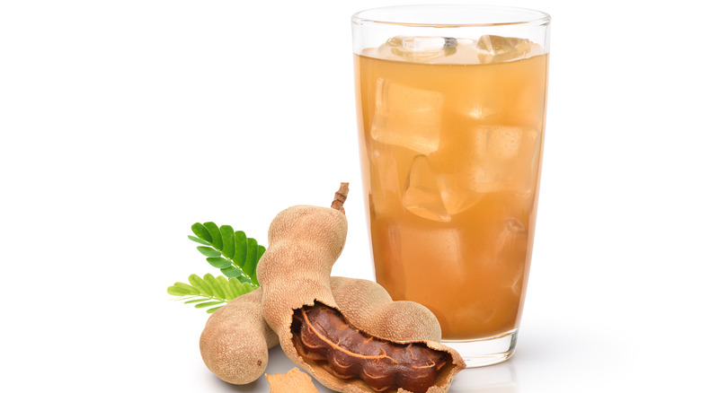 Tamarind fruit and juice in glass