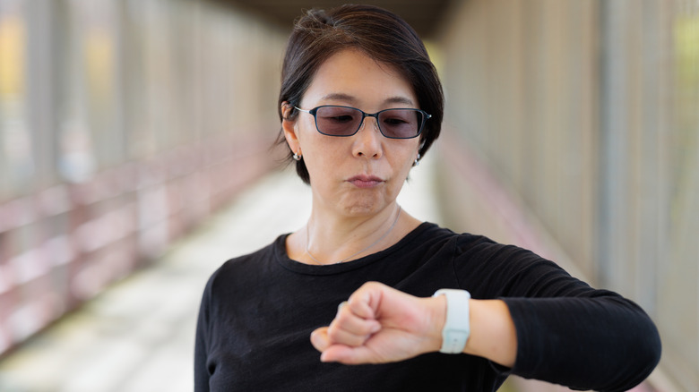 Woman checks watch