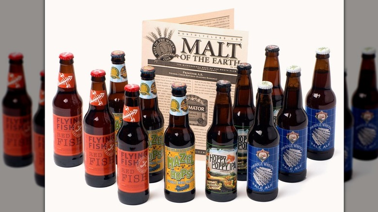 bottles of beer and Malt of the Earth flyer on white background