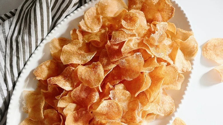 Homemade potato chips on ceramic platter