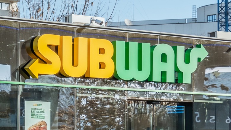 Subway sign on building exterior