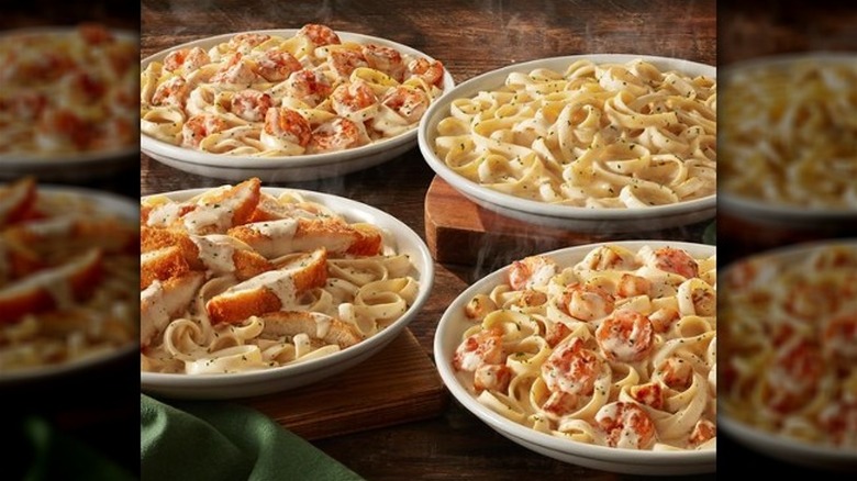 bowls of Alfredo with different meats