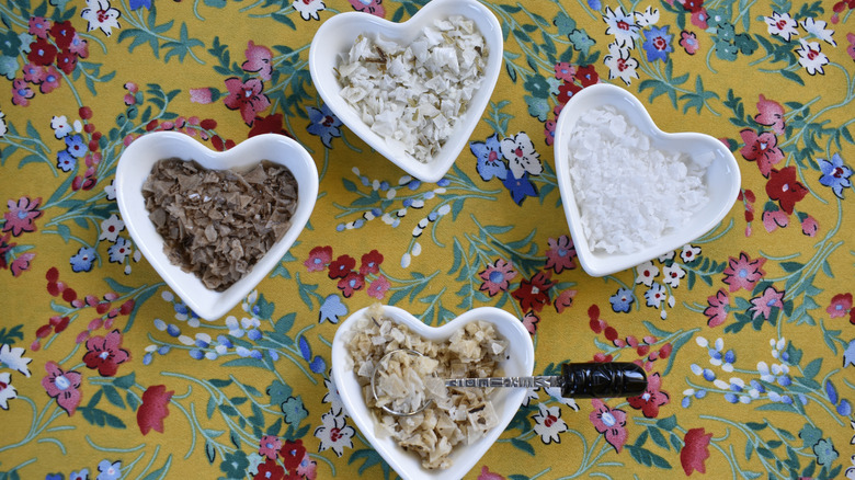 Four different kinds of salt in heart-shaped bowls