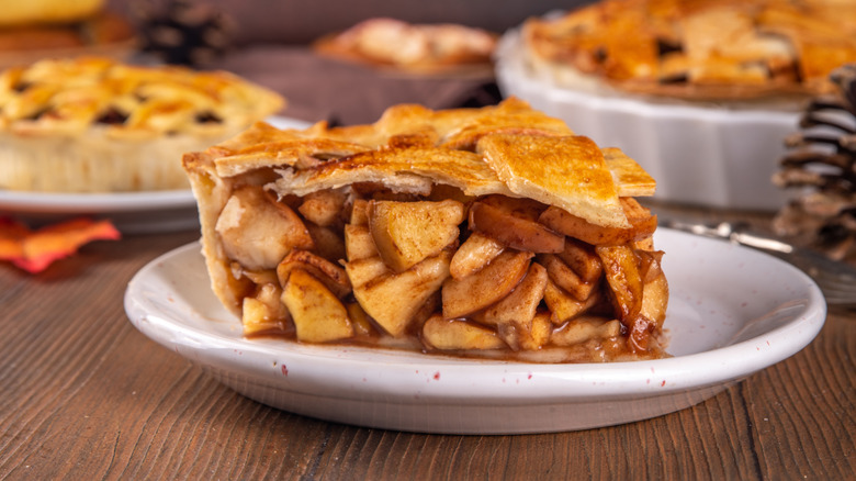 Thick slice of apple pie on a white plate