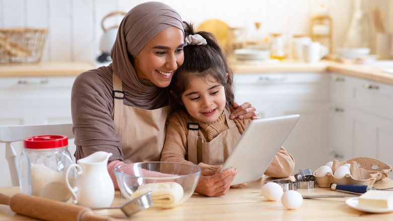 mother and daughter reading recipe