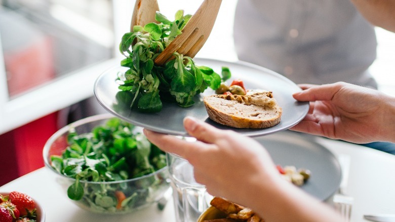 salad getting put on plate