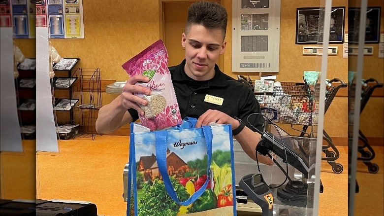 cashier bagging items at Wegmans