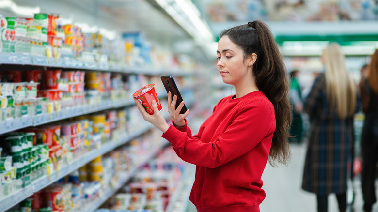 woman scanning product with phone