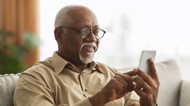 man looking at cell phone