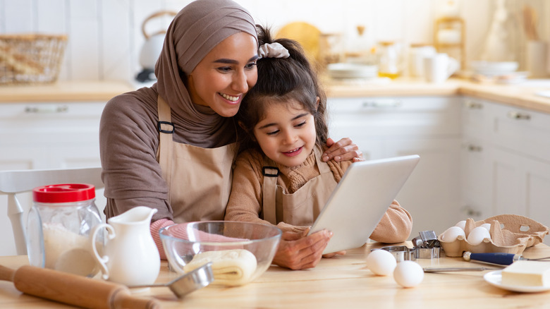 mother and daughter reading cookie recipe