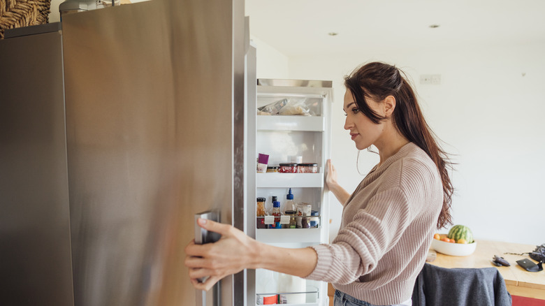 woman opening refrigerator