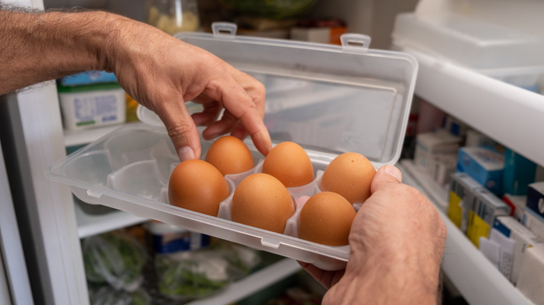 carton of eggs by refrigerator