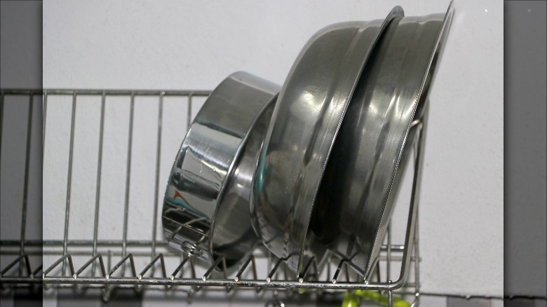 stainless cookware in dish drain