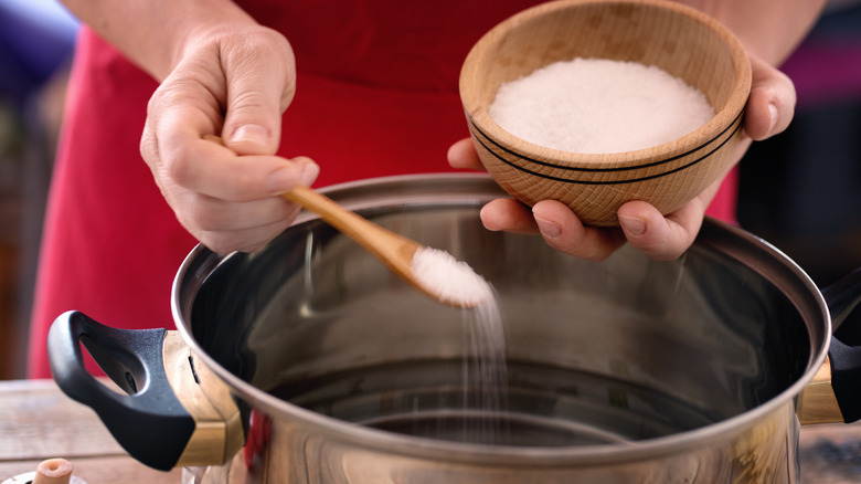 adding salt to stainless pot