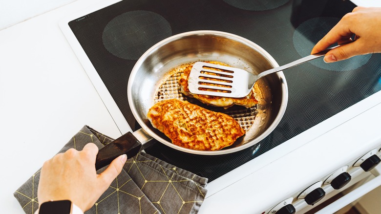 spatula over stainless frying pan