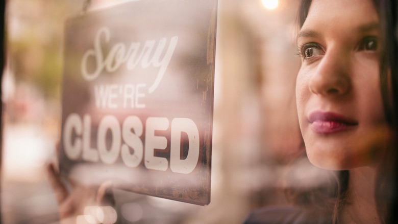 Woman store closed sign