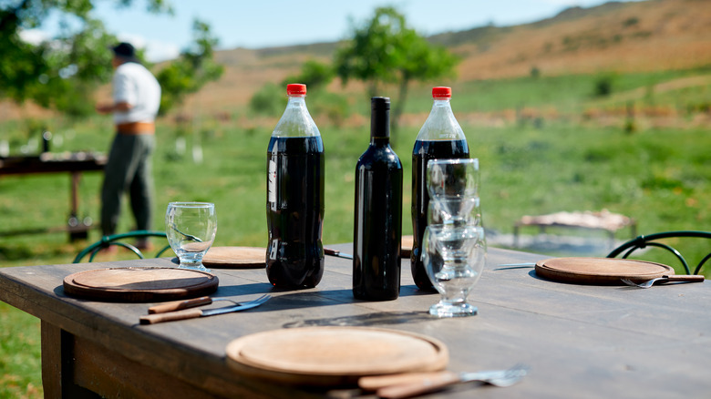 soda and wine bottles on table