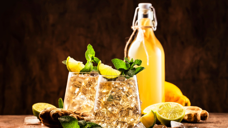 two cocktail glasses and bottle