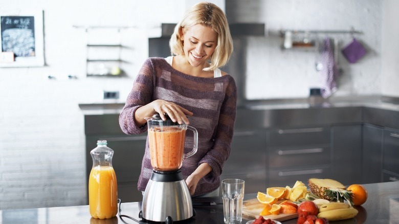 pouring orange juice into blender