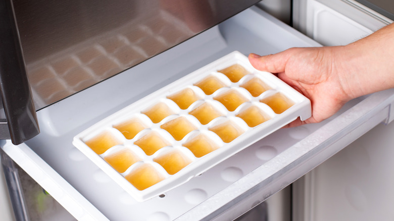 ice cube tray with orange juice