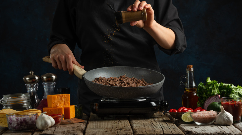 seasoning taco meat in pan