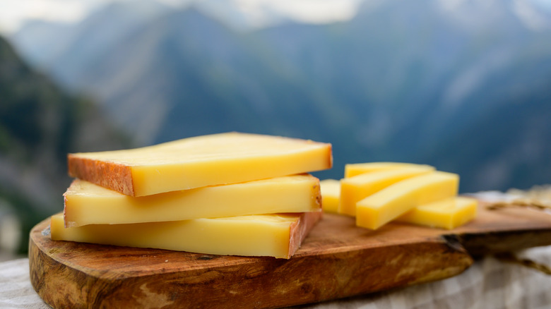 Comte cheese with Alps background