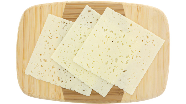 Slices of havarti on cutting board