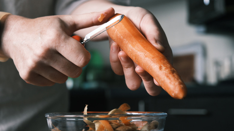 hand peeling carrot
