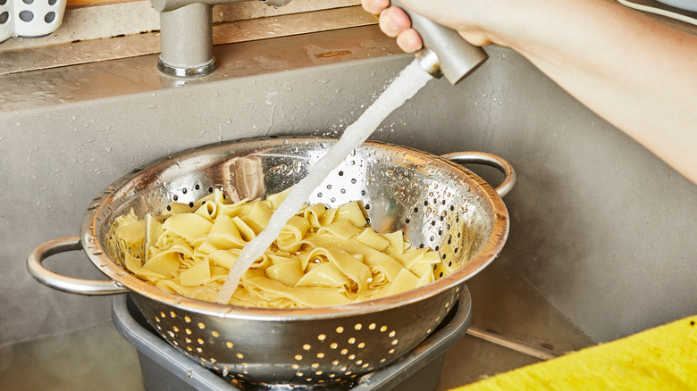 rinsing pasta in sink