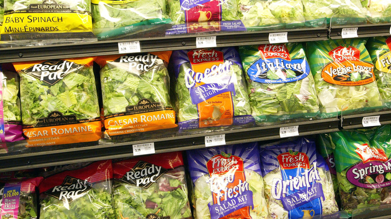 bags of lettuce on shelves