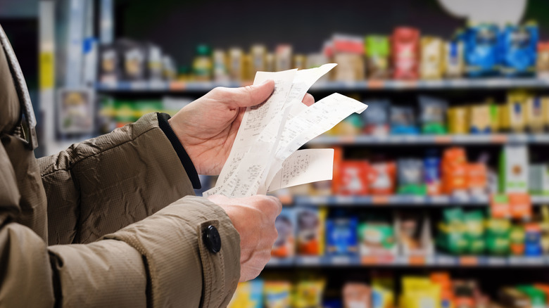 person holding receipt