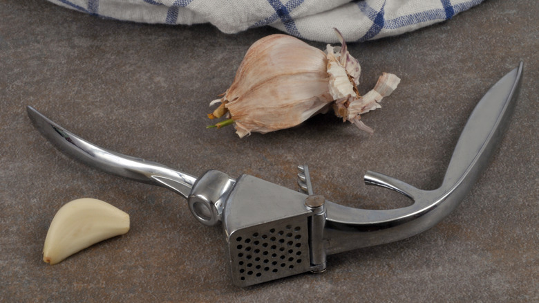 garlic press with garlic cloves