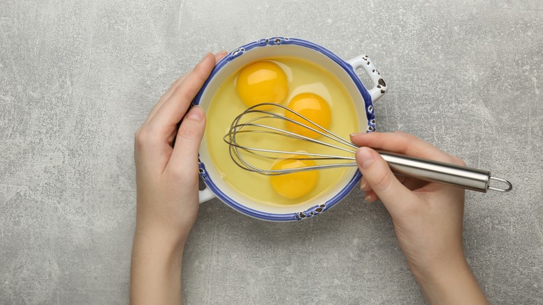 whisk in bowl of eggs