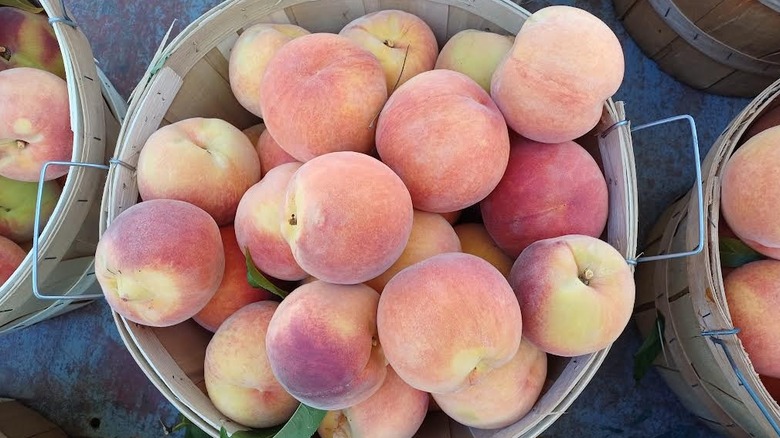 Peaches in a wooden bucket