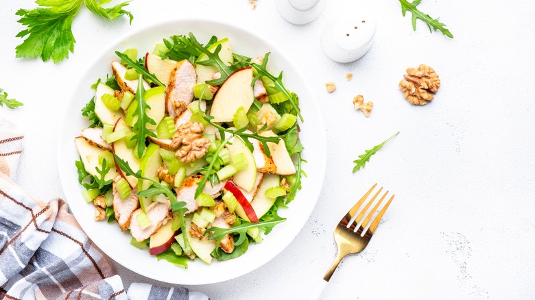 apple walnut chicken salad with fork and napkin