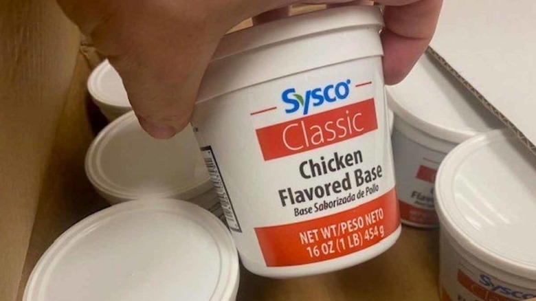 hand holding Sysco Classic Chicken Flavored Base