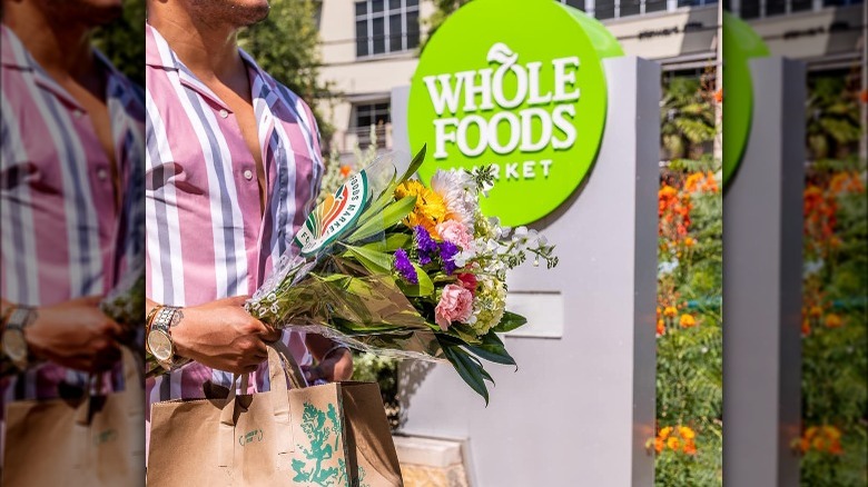 person carrying flowers near Whole Foods