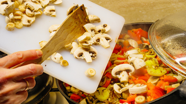 Adding mushrooms to a pot