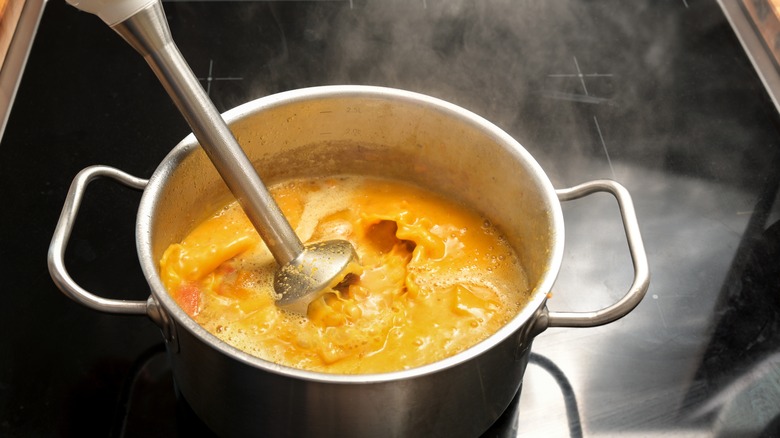 Puréeing soup with immersion blender