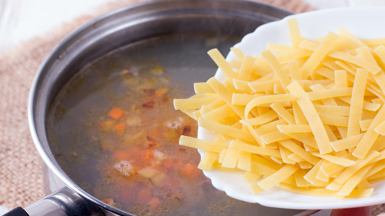 Adding noodles to soup