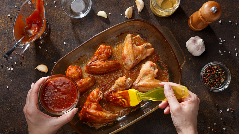 brushing marinade on chicken wings